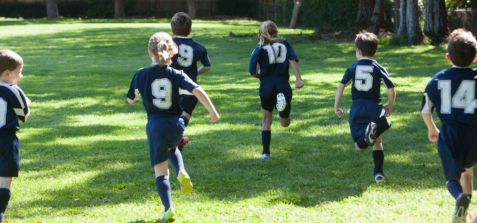 Kids playing soccer running